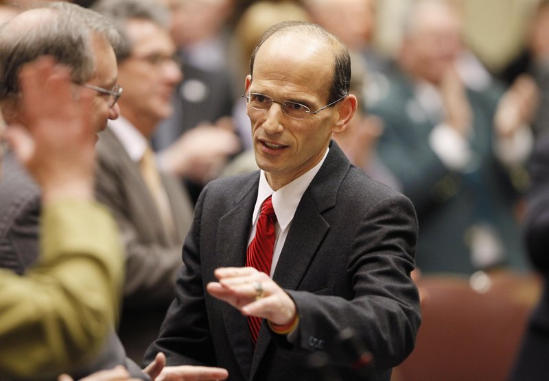 Gov. John Baldacci greets legislators after his State of the State address in 2009 at the State House in Augusta. Rather than see the bad economy as a hindrance, Baldacci insists it enabled him to push through changes that, in a good economy, would not have been possible.