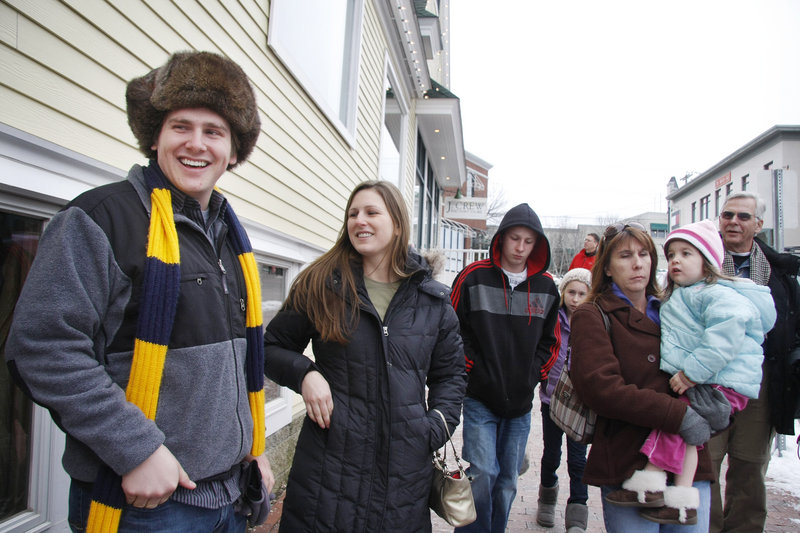 Neal Dixon, left, of Michigan, and his sister, Alexis Dixon of California, look forward to a lobster roll lunch while shopping in Freeport on Sunday.