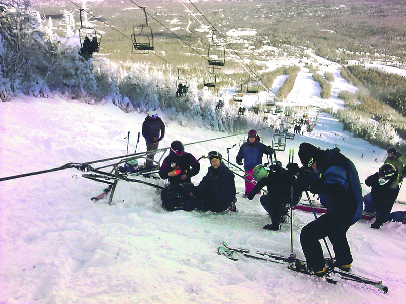 A skier who was on the chairlift is assisted by others Tuesday morning within minutes after the derailment on a mountain at Sugarloaf.