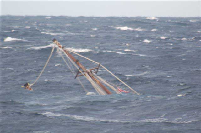 A mast of the 88-foot sailing vessel Raw Faith protrudes from the water as the boat sinks in approximately 6,000 feet of water about 166 miles southeast of Cape Cod, Mass., Wed., Dec. 8, 2010. The crew of the Kittery, Maine, Coast Guard Cutter Reliance remained on scene until the vessel sank. Coast Guard photo by Coast Guard Cutter Reliance crew.