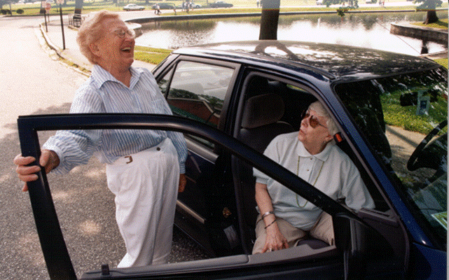 Martha Giles, left, a driver for ITNPortland who won a White House award for her service, interacts with a client in this undated photo.