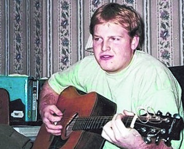 Paul Victor Galambos III, who took medication for his mental illness, went to Buxton schools and loved to play guitar, as shown in this undated photo.