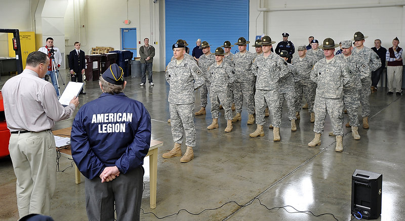 Peter Morin, left, representative for Sen. Olympia Snowe, reads a message during the send-off for the Army Reserve’s Company C, 1st Battalion, 304th Regiment, on Saturday. With him is Jim Harper, right, commander of American Legion Owen-Davis Post 96 in Saco.