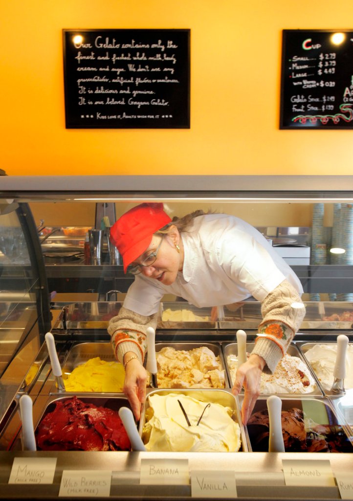 Mariagrazia Zanardi settles a fresh batch into the display case at Gorgeous Gelato on Fore Street in Portland.