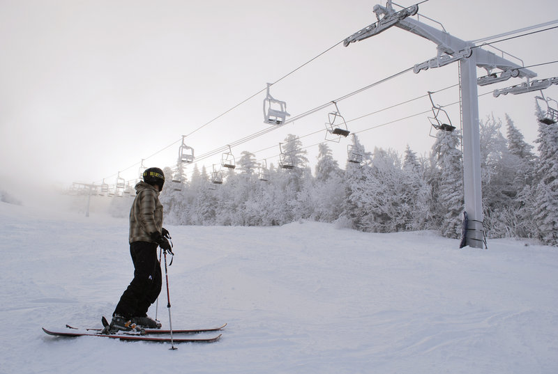 Chairs on Sugarloaf's Spillway East lift, on the left side of the tower, remain coated in ice and snow Friday. Its closure has forced skiers to use Spillway West and switch to another lift to reach higher parts of the mountain.