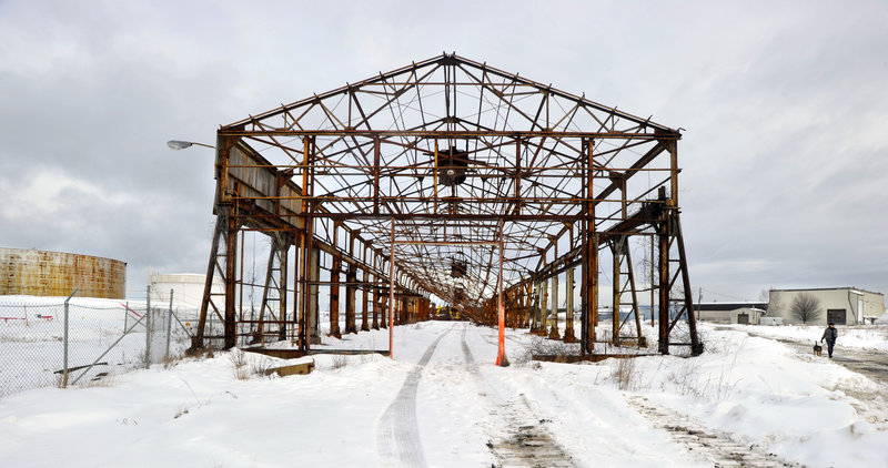 Workers with P.K. Contracting Inc. on Wednesday start to remove the last of the oceanfront structures where Liberty ships were built in South Portland.