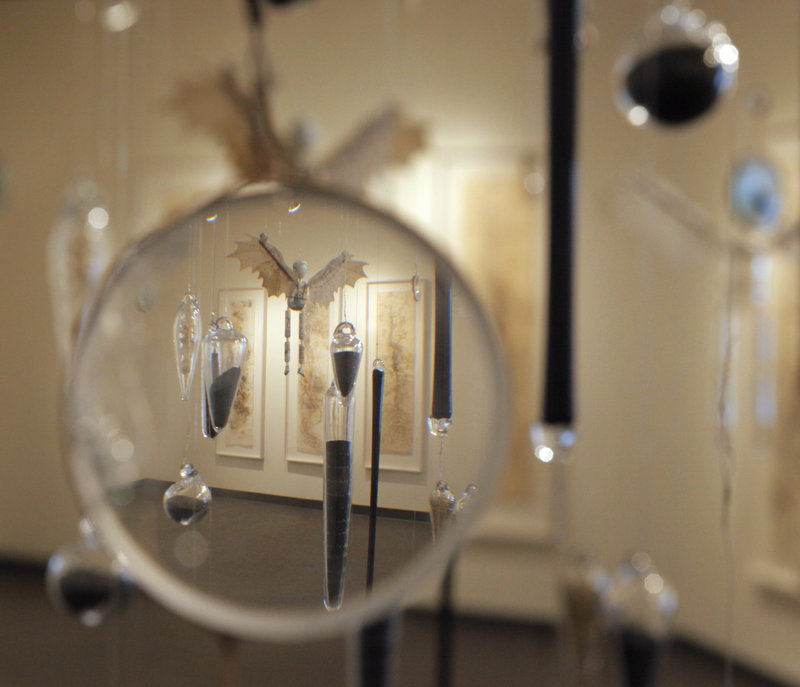 The centerpiece of Alison Hildreth's "The Feathered Hand," at the Art Gallery of the University of New England in Portland, is an installation of winged, marionette-like figures suspended in midair.