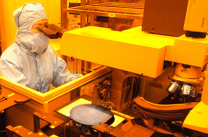 A worker inspects a wafer at Fairchild Semiconductor in South Portland. Both Fairchild and National Semiconductor would like Maine's solvent regulations to be aligned with less-strict federal laws.