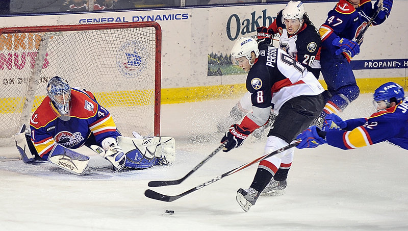 Admirals goalie Mike Smith keeps close watch as Pirate Dennis Persson’s shot is broken up by Norfolk’s Scott Jackson on Tuesday night at the Cumberland County Civic Center. Looking on is Portland’s Dennis McCauley.