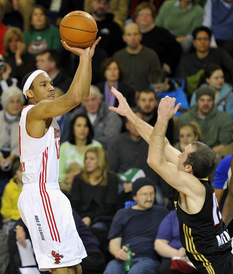 Maine’s Avery Bradley goes up for a 3-pointer against Erie’s Blake Ahearn in the second half Friday night at the Portland Expo. The Red Claws lost, 113-109.