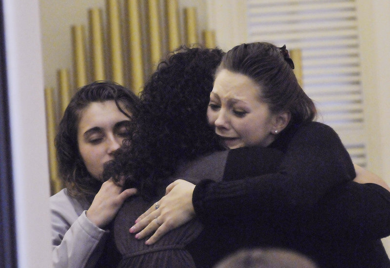 Amanda Gove, right, Megan Waterman's sister, is comforted by friends during visiting hours before a memorial service on Sunday.