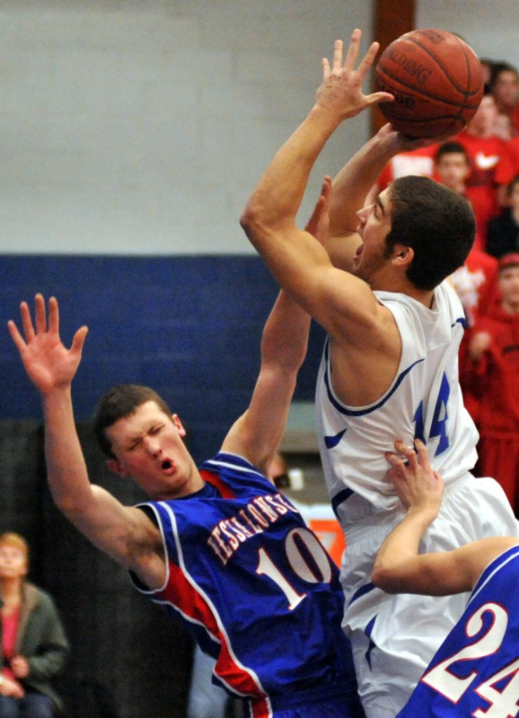 THAT HURTS: Messalonskee’s Andrew Wilson, left, draws an offensive foul on Lawrence’s Spencer Carey in the first quarter Thursday night at Lawrence High School.