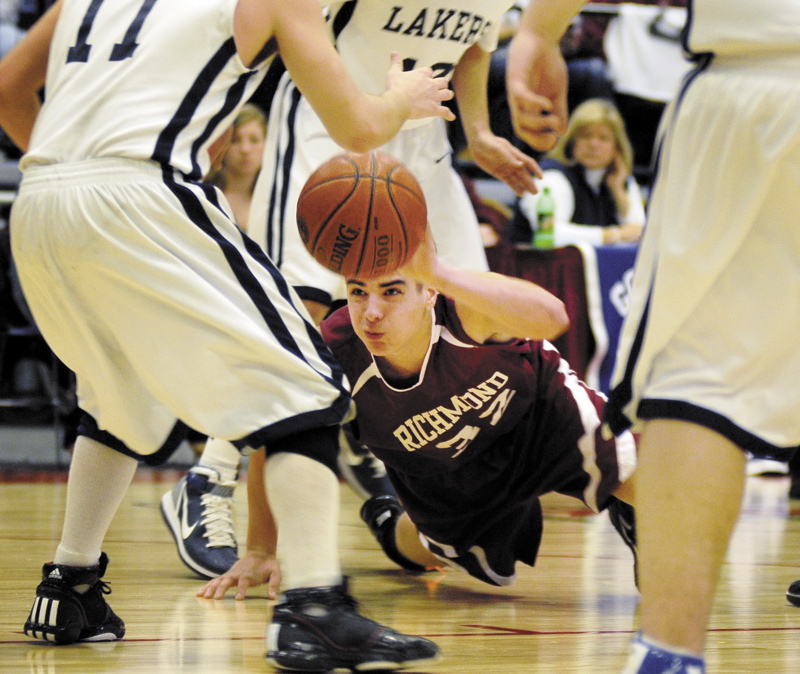 Wade Tuttle of Richmond tries to get rid of the ball while surrounded by Greenville players during their Western Class D semifinal Wednesday morning at the Augusta Civic Center. Richmond advanced with a 63-47 win.