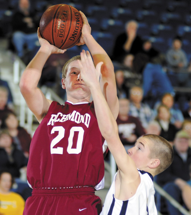 Ben Carver takes a shot under pressure from Greenville's Henry Hersey.