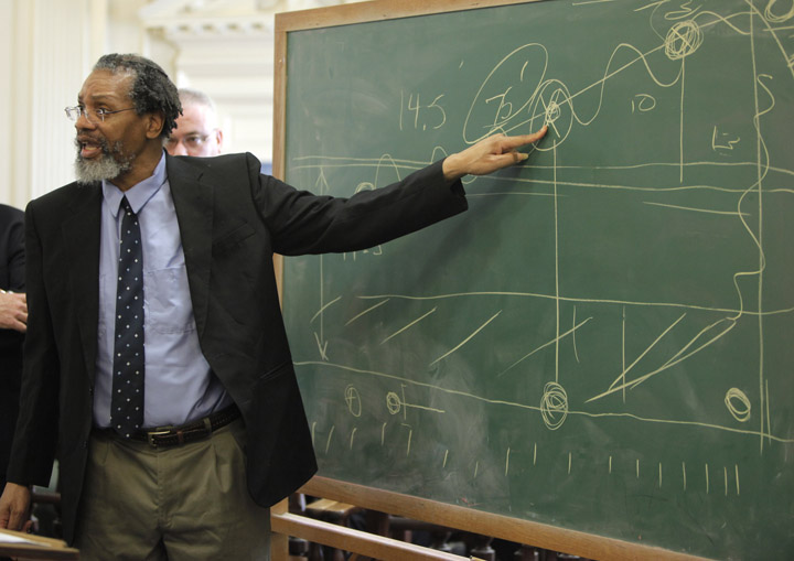 Rory Holland points to a diagram he drew on a chalkboard while arguing for a motion for acquittal during his sentencing in York County Superior Court in Alfred on Monday. Justice Roland Cole denied Holland's motion and sentenced him to life in prison on both counts of murder.