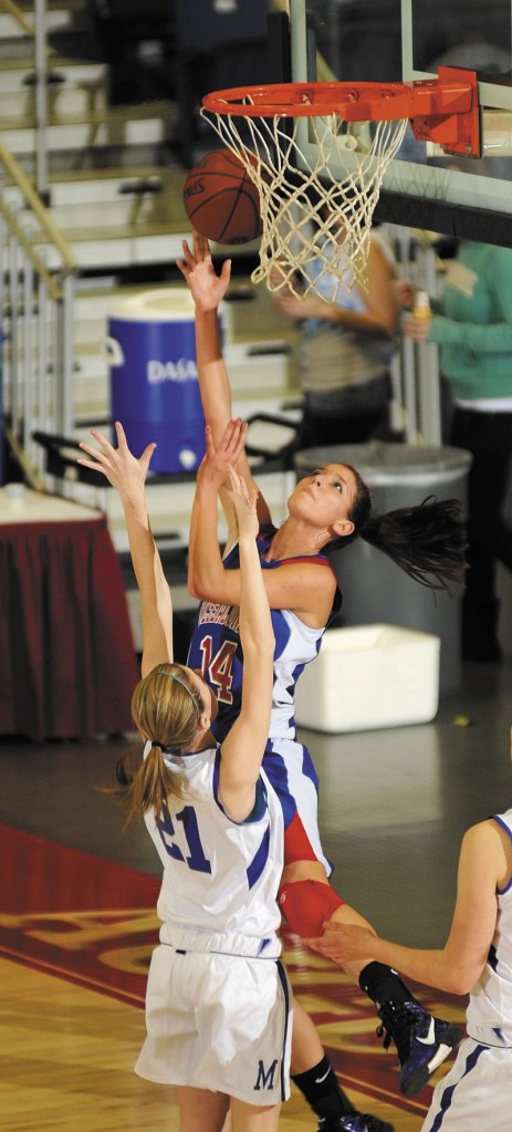 TO THE HOLE: Messalonskee junior forward Megan Pelletier (14) shoots over Morse senior guard Lindsay Watts during an Eastern Maine Class A quarterfinal game Friday at the Augusta Civic Center.