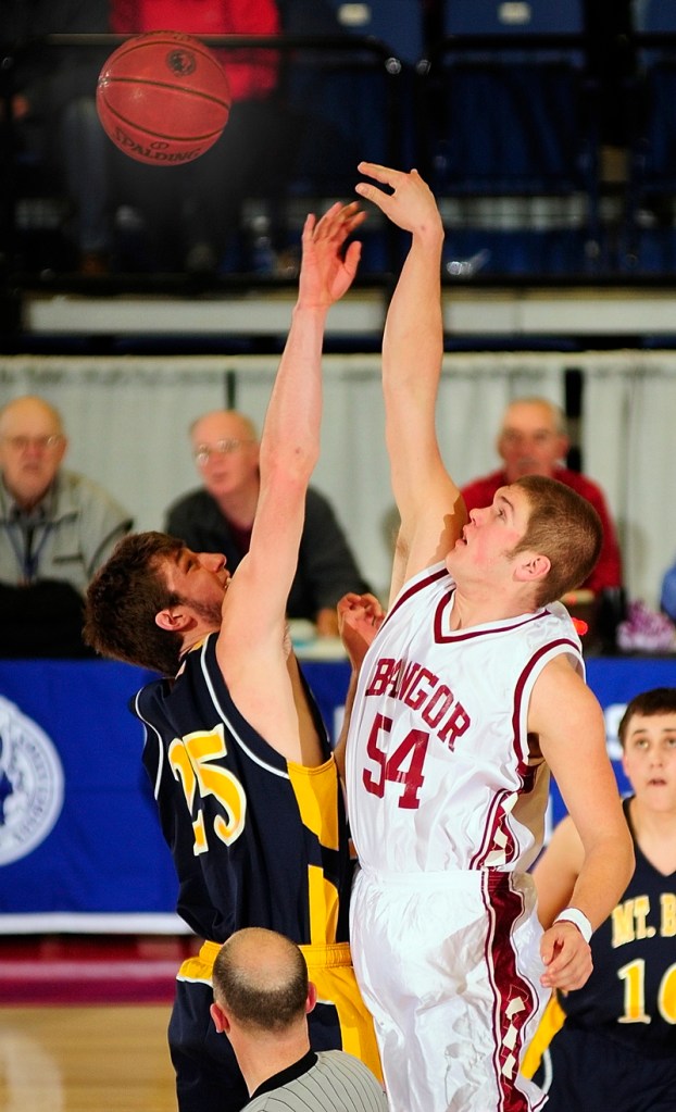 Cam Sennick, left, of Mt. Blue and Josiah Hartley of Bangor go after the tipoff to start their Eastern Class A semifinal Wednesday at the Augusta Civic Center. Top-ranked Bangor won, 41-34.