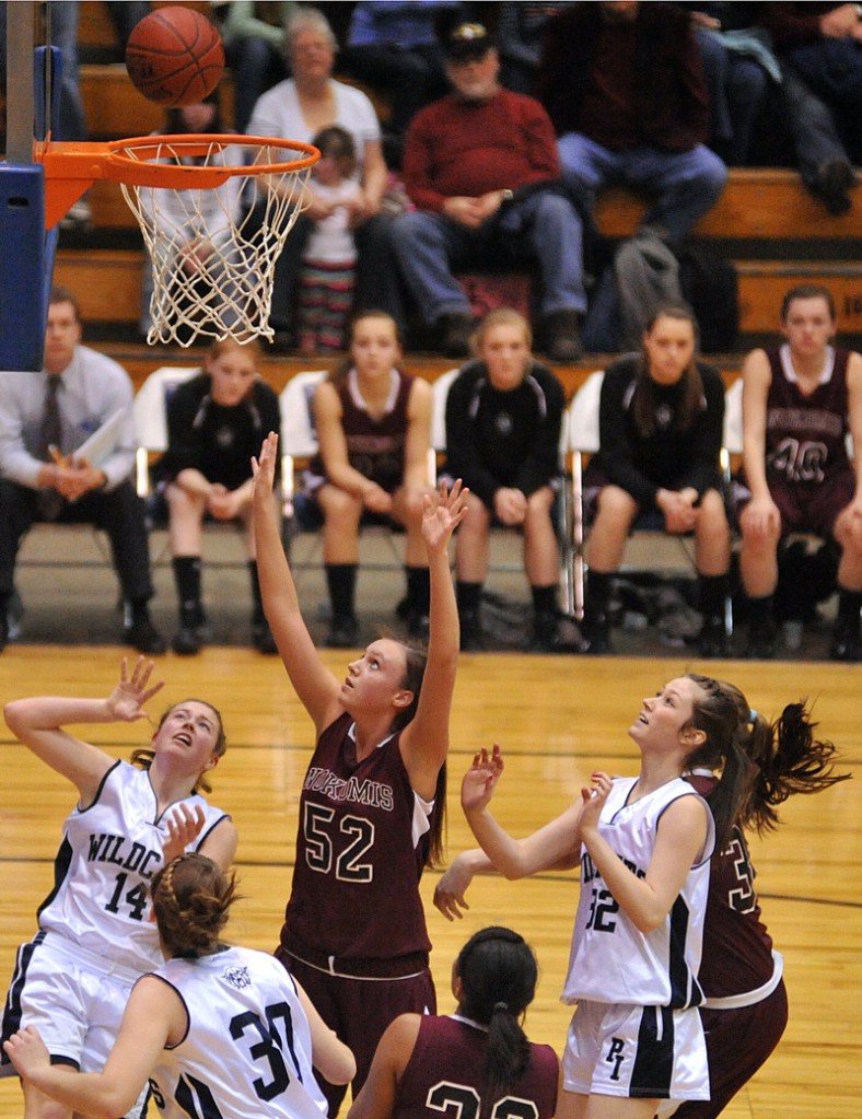 Danielle Watson, 52, of Nokomis looks up for a rebound between three Presque Isle.