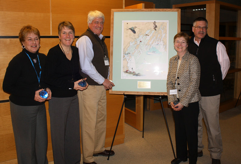 Members of the Bennett family, which owns Oakhurst Dairy, stand beside the Friends of Casco Bay Award they received at the event. From left, they are Althea Bennett McGirr, Mary Ellen Bennett Tetreau, Bill Bennett, Jean Bennett Driscoll and John Bennett.