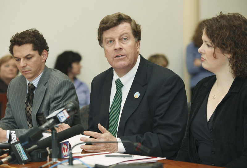 Senate Democratic leaders Barry Hobbins of York, center, and Justin Alfond of Portland react to the two-year state budget outlined by Gov. Paul LePage earlier in the day.