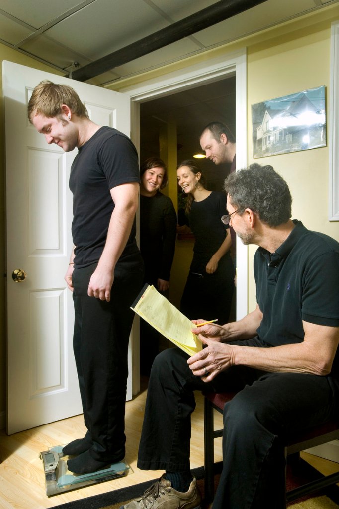 With owner David Turin recording the numbers and his David's Restaurant comrades looking on encouragingly, Nate Marchand hops on the scale for the weekly weigh-in in Turin's "Biggest Loser"-style challenge.