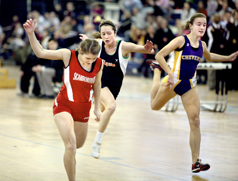 Nicole Kirk of Scarborough stretches to win the senior 40 in 5.38 seconds. Maria Curit of Biddeford, center, was fourth and Caroline Summa of Cheverus was fifth.