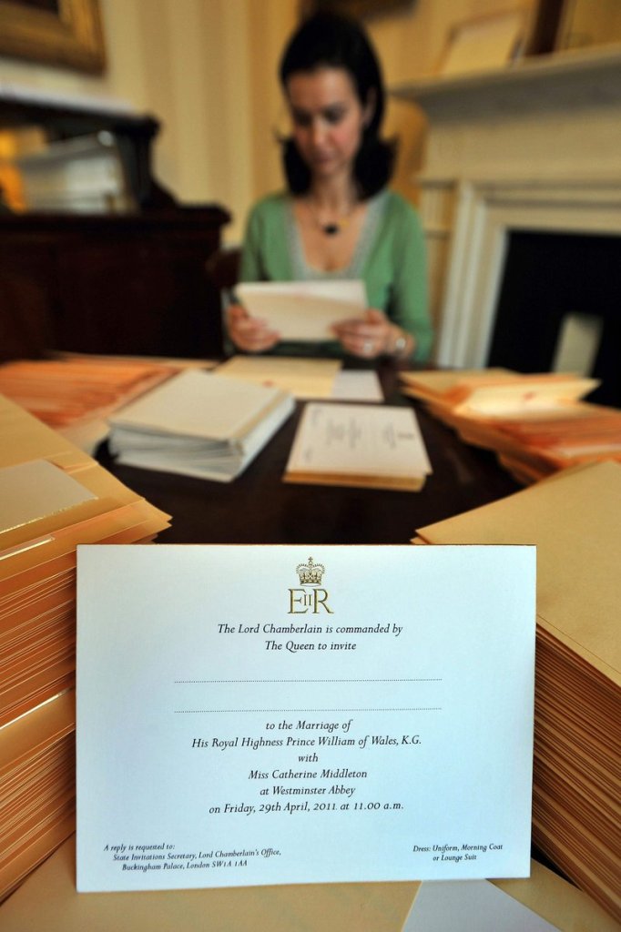 An unidentified employee of the Lord Chamberlain’s Office places invitations to the wedding of Prince William and Kate Middleton into envelopes at Buckingham Palace. Soccer star David Beckham and his wife are reportedly on the guest list.