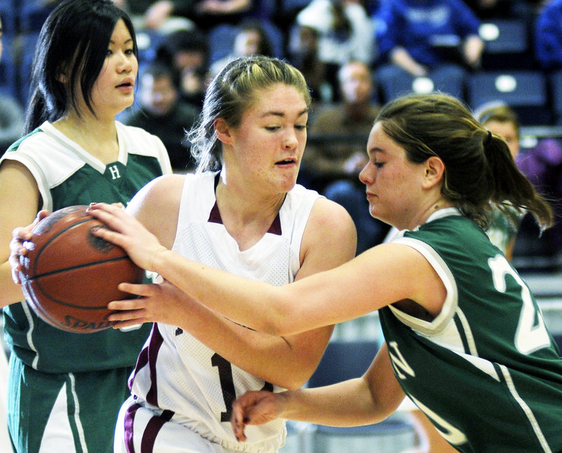 Brianna Snedeker of Richmond tries to keep the ball away from Hebron Academy's Mar Bartolome during their Western Class D girls' quarterfinal in Augusta. Richmond won, 53-38.