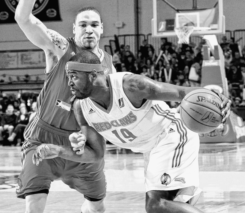 Mario West of the Maine Red Claws drives around Richard Roby of the Rio Grande Valley Vipers on Thursday at the Portland Expo. The Red Claws fell to 14-22.