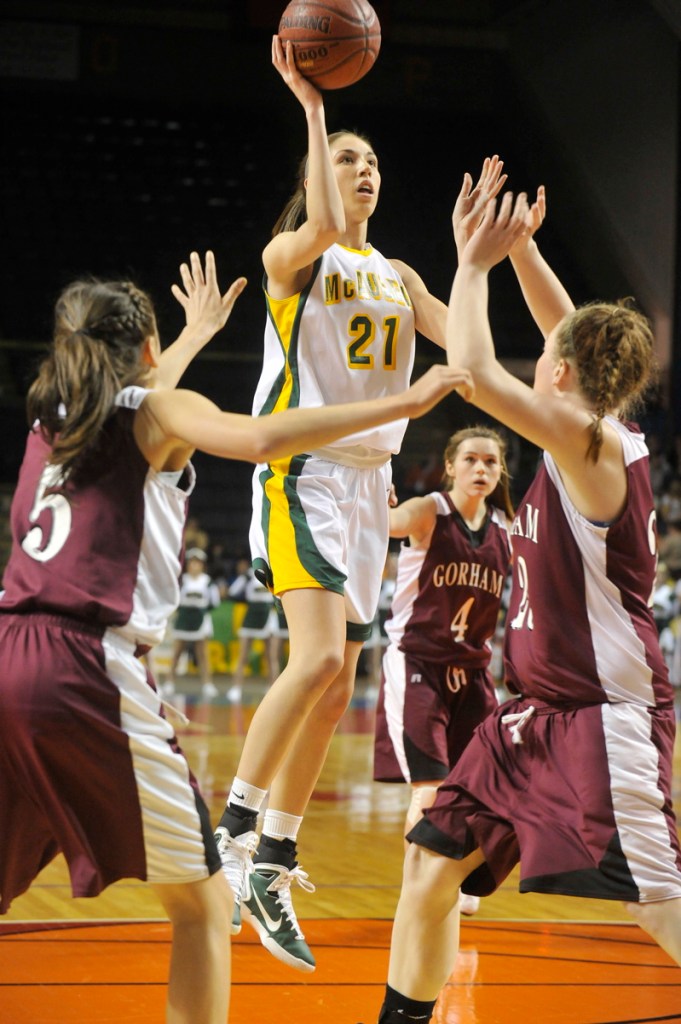 Alexa Coulombe of McAuley finds room in the middle of the Gorham defense to get off a shot at the Cumberland County Civic Center. Defending are Mia Rapolla, left, and Lexi Merrifield. McAuley won, 39-30.