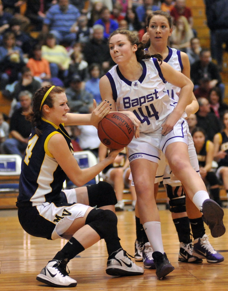 Ericka Christensen, left, of Medomak Valley battles for a loose ball with Abby Pyne of John Bapst.
