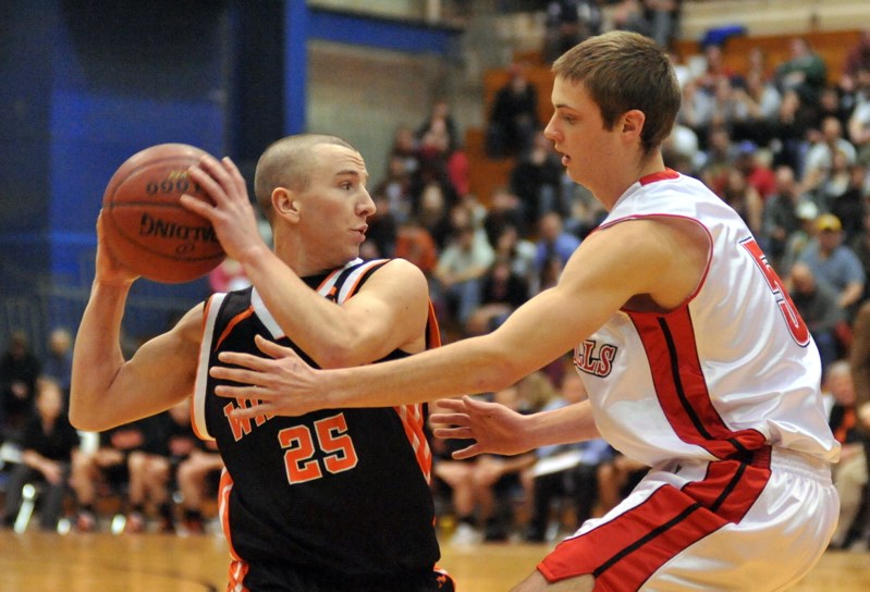 Justin Murray of Winslow looks to pass under pressure from Nathan Catell of Camden Hills.