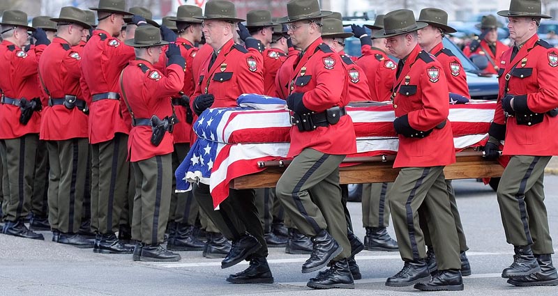 Maine Game Warden pall bearers carry the casket of Warden Service Pilot Daryl R. Gordon from the hearse into the Augusta Civic Center at the start of celebration of his life this afternoon.