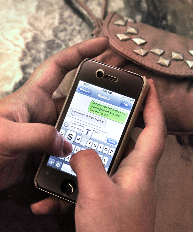 Junior Sophea Prak sends a text during lunch.