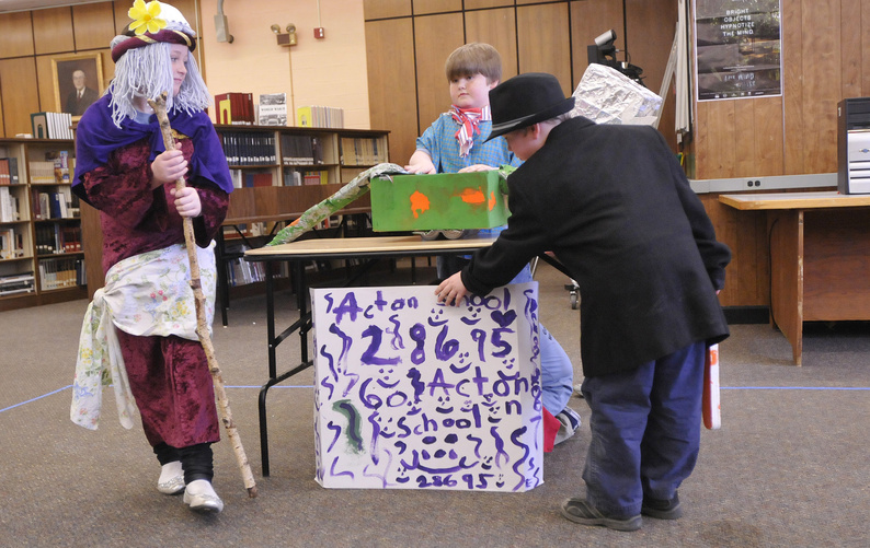 Acton Elementary School students, from left, Hunter Ham, 8, Sam Toussaint, 8, and Joshua Rousleau 6, perform with their team during Money Maker.