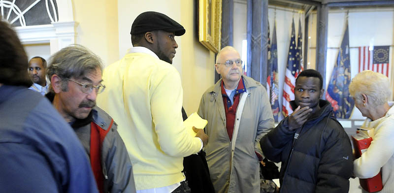 People wait in the Hall of Flags at the Statehouse Monday for a chance to address the Legislature's Appropriations Committee. An estimated 100 people rallied in the Hall, outside of the Governor's office, before lining up to speak to representatives about proposed budget cuts.