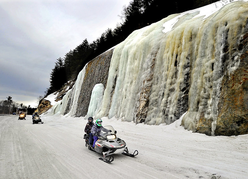 Connor Coughlin, front, and Kara Barnhart, both of Connecticut, join other vacationing snowmobilers on a recent ride in the Bethel area run by Sun Valley Sports.