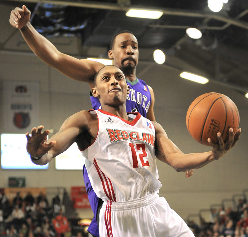 Kenny Hayes of the Red Claws beats Dakota's Javaris Crittenton and drives in for a layup Thursday night at the Portland Expo. The Wizards rallied late for a 104-103 win.