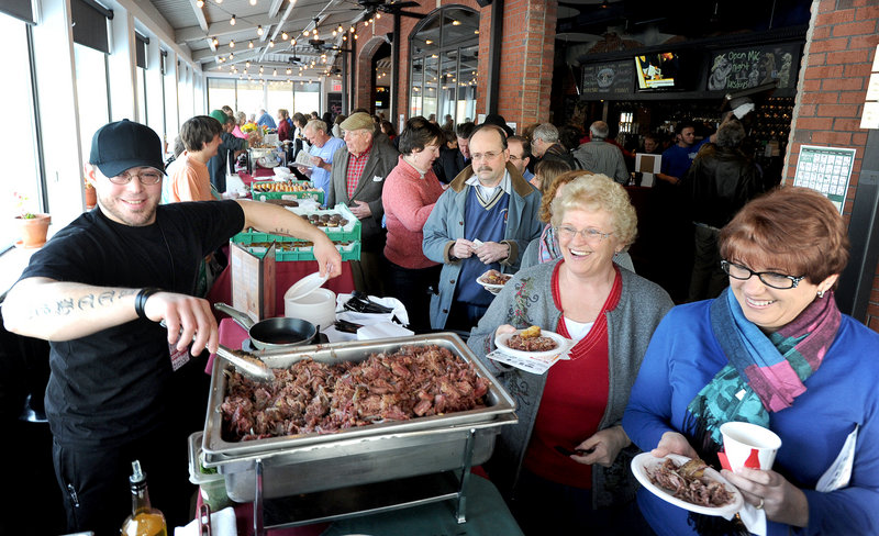 Bintliff’s American Cafe line cook Matt Sanchez dishes out Black Angus Corned Beef Hash at the event, a benefit for Preble Street.
