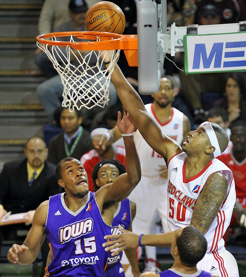 Magnum Rolle of the Maine Red Claws puts back an offensive rebound Friday night in front of Marqus Blakely of the Iowa Energy in the first quarter at the Portland Expo. The Red Claws lost 99-90 and fell to 14-25 on the season.