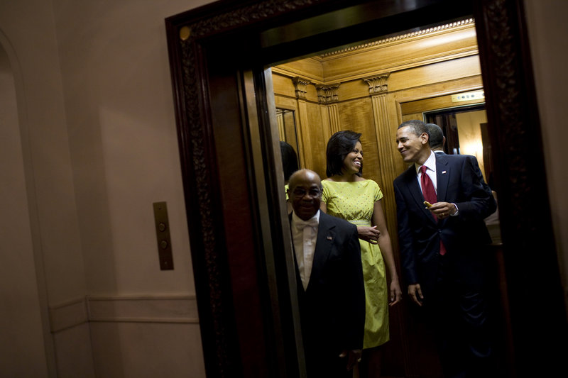 President Obama holds a tortilla from the buffet table at the White House Cinco de Mayo celebration as he and first lady Michelle Obama take an elevator to the private residence after the event on May 4, 2009.
