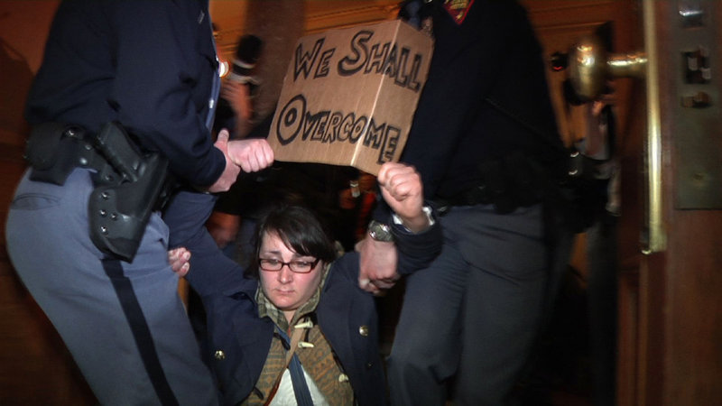 Police remove a demonstrator last week during a protest at the Capitol in Madison, Wis. Police carried dozens of protesters from a hallway leading to the Wisconsin Assembly, where a vote was held on a bill that would take away public workers collective bargaining rights.