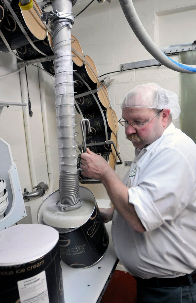 Les Perry fills 3-gallon tubs with Blueberry Ripple ice cream at Gifford’s Ice Cream in Skowhegan. Among its Maine-themed flavors: Moose Tracks.