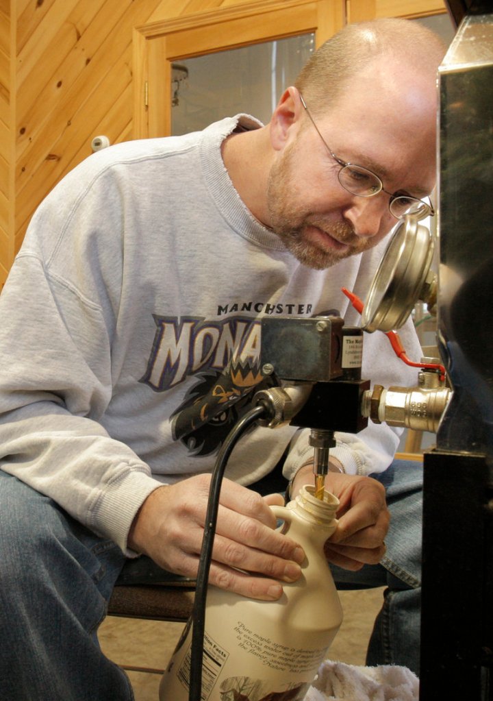 Reporter Ray Routhier fills a jug of syrup at the Thurston and Peters Sugarhouse.