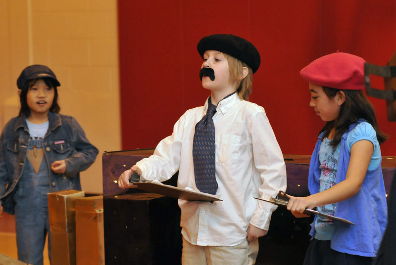 Team members from Village Elementary School in Gorham, from left, Kiera Emerson, 8, Trevor Gava, 9, and Jade Wu, 8, give their Extreme Mouse Mobiles presentation.