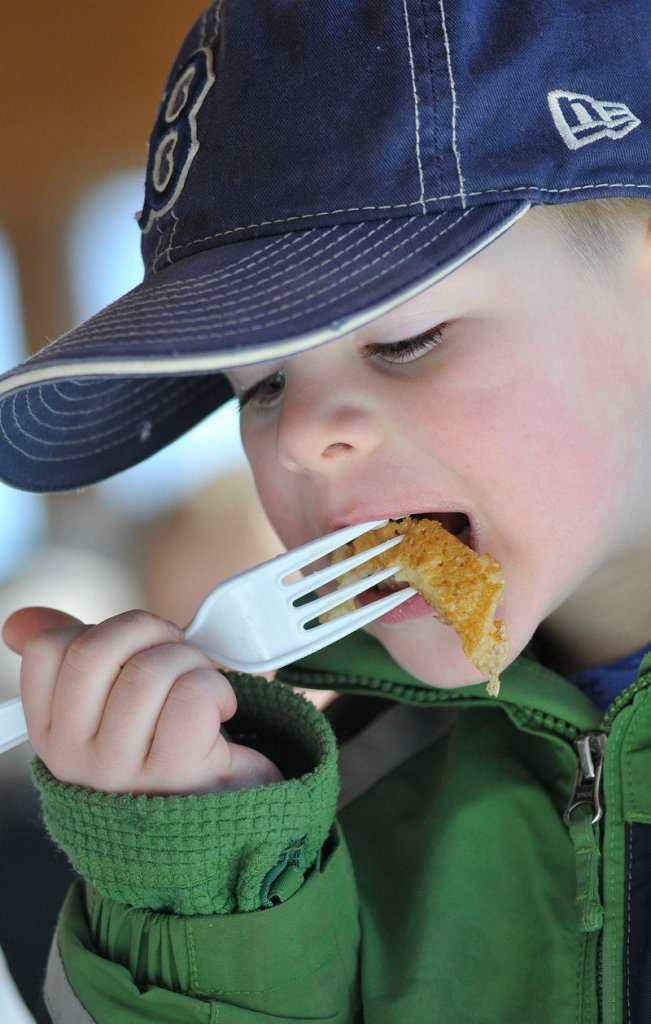 Balin Pelletier, 5, of Saco enjoys the taste of Maine Maple Sunday at Harris Farm.