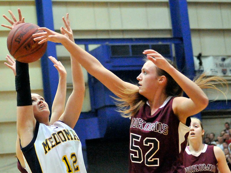 STRONG INSIDE: Nokomis’ Danielle Watson, right, blocks a shot from Medomak Valley’s Lindsay Ranquist in the Eastern Maine Class B championship game Saturday at the Bangor Auditorium. Watson is a big reason the Warriors will play Leavitt for the Class B state championship at 7 p.m. Friday in Portland.