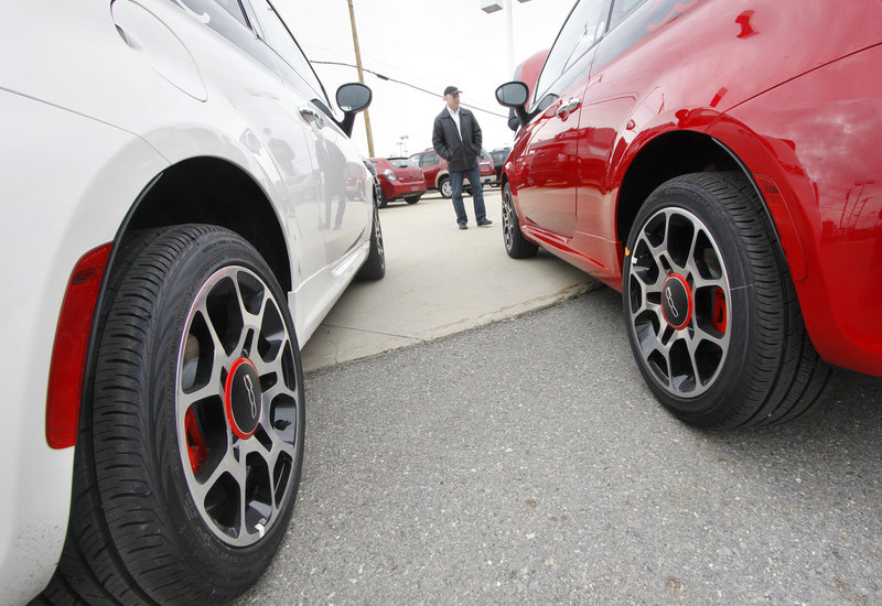 Jack Quirk shows off two new Fiat 500s at his dealership in Portland. He expects to get more models when he completes work on a showroom – a studio in Fiat parlance – with rounded corners.