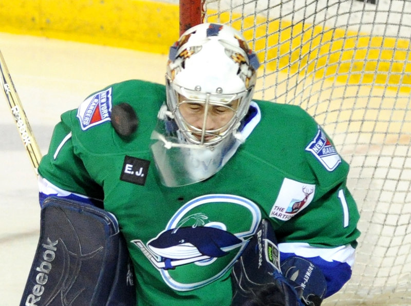 Connecticut goalie Dov Grumet-Morris takes a direct hit to his mask and is shaken up Thursday night during the second period of a 5-4 loss to the Portland Pirates at the Cumberland County Civic Center. Grumet-Morris left the game but said afterward that he was fine.