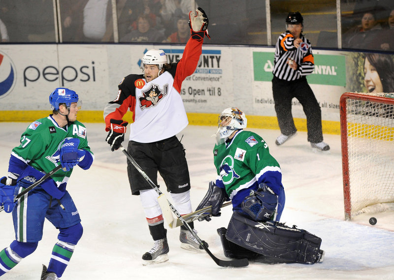 Dennis McCauley of the Portland Pirates celebrates in front of Whale goalie Dov Grumet- Morris after Travis Turnbull scored for Portland.